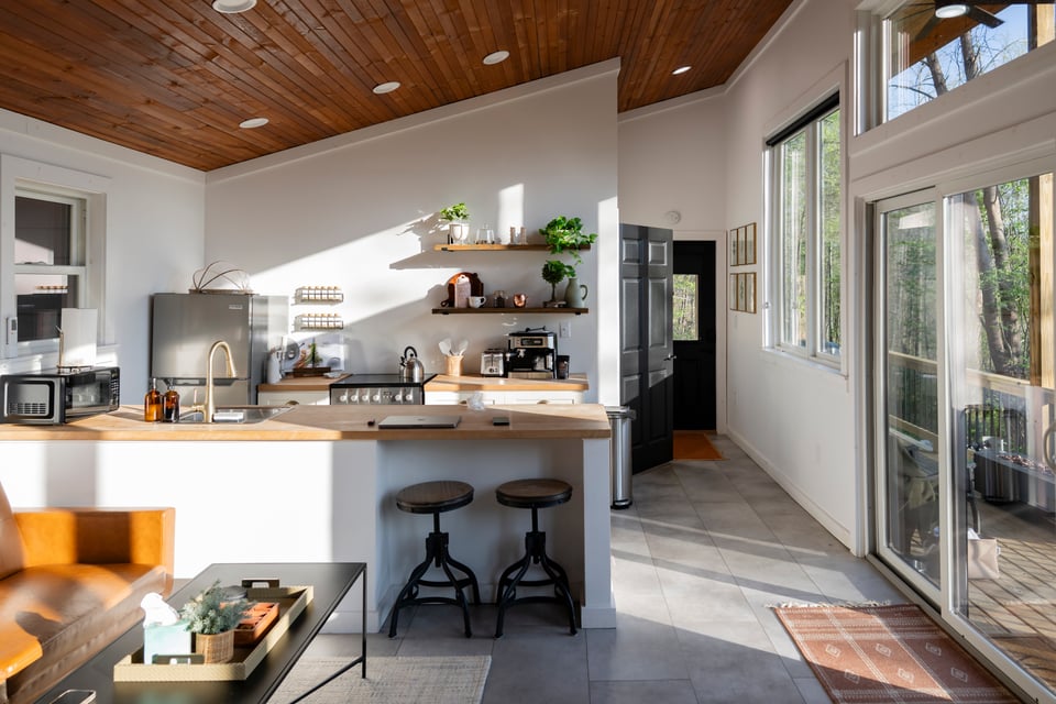 Kitchen with floating shelves, espresso machine and plants